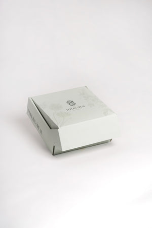 Coffret Petit Secret de Colibri fermé, avec design floral et logo Fleurs de Peau.