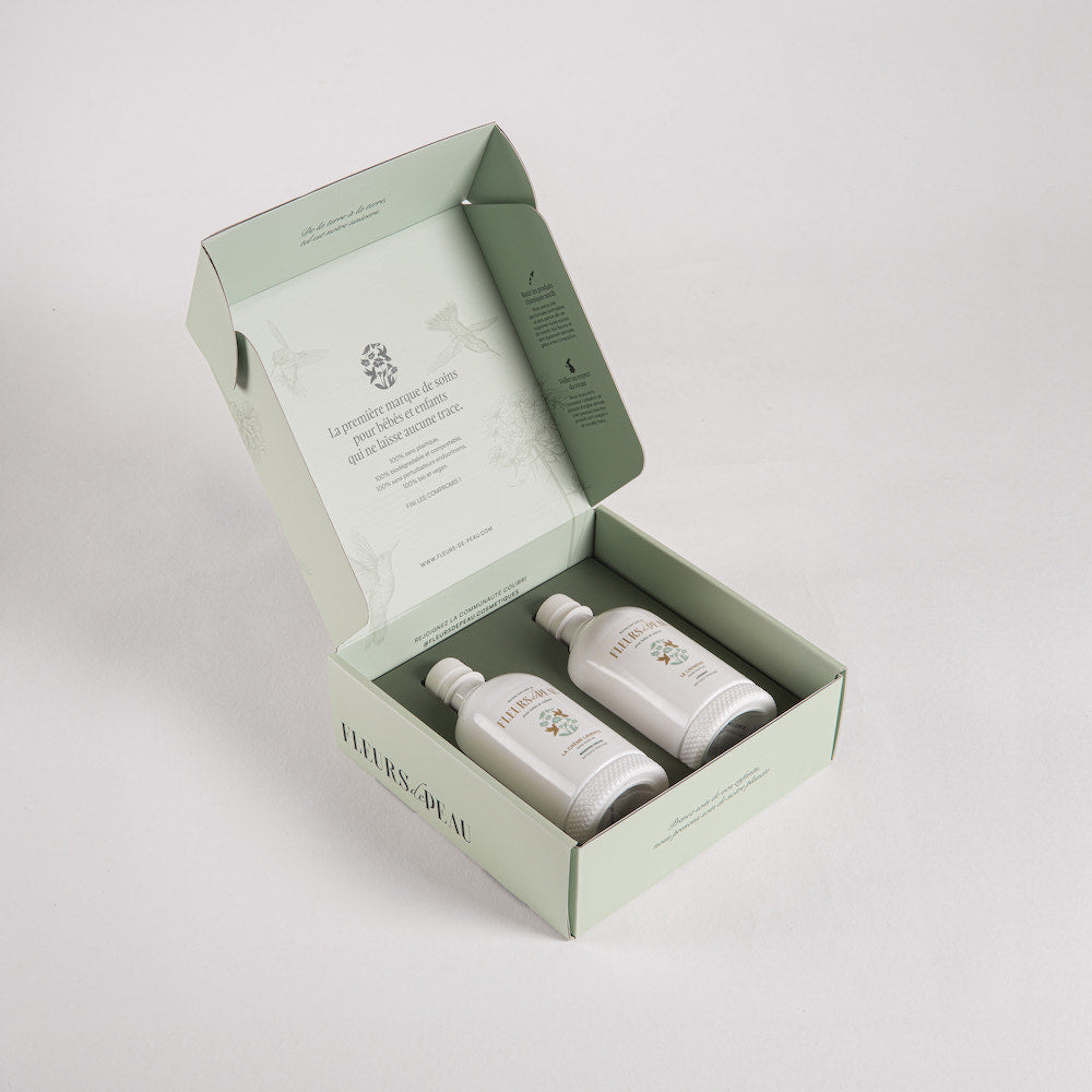 Coffret Petit Secret de Colibri avec deux soins bébé bio présentés dans une boîte élégante.